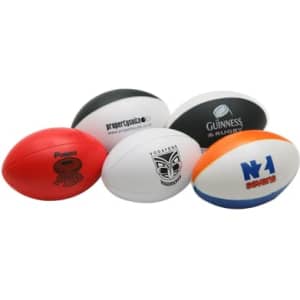 A collection of stress balls shaped like Australian footballs in various colours, including red, white, and black. Each has a logo.