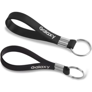 A black silicone key ring with a metal keyring attachment and a logo. Two key rings are displayed in the image.