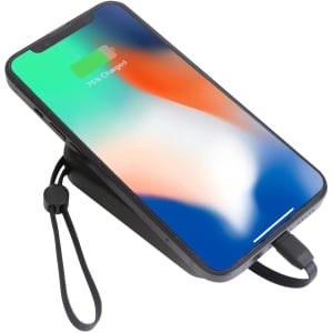 A black portable power bank with a phone charging on top, showing a green and orange screen.