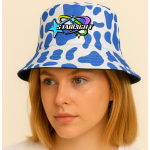 A bucket hat with a blue and white cow print design and a logo on the front.