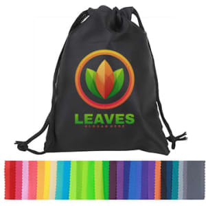 A black drawstring bag containing a variety of fabric swatches in multiple colours, including vibrant shades of pink, green, and purple.