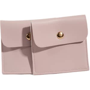 A square pale pink PU leather jewelry pouch with a button closure and stitched detailing. Features a logo.