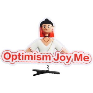 A custom felt hair clip featuring a character with red hair and the phrase "Optimism Joy Me" in bold text.