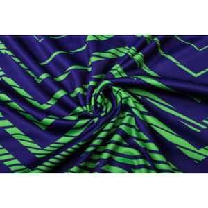 A vibrant navy and green patterned fabric, showcasing a wavy design with twisting folds.