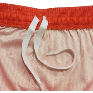 Breathable sport shorts in peach with an orange waistband and white drawstrings. Features a logo.