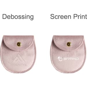 A pink oval velvet jewelry pouch with a button closure and branding options for debossing and screen printing.