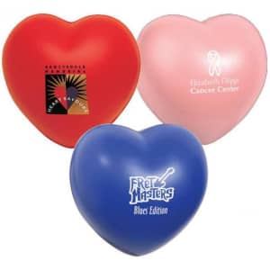 Three heart-shaped stress relievers in red, pink, and blue, each featuring a logo.
