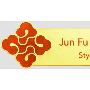 A custom metal name badge featuring a decorative red design and a gold background.