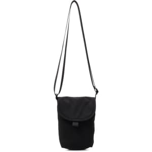 A small black canvas shoulder bag with a long strap and a flap closure. It features a branded logo.