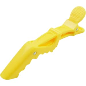 A yellow anti-slip positioning alligator clip with a textured grip and a logo on its surface.