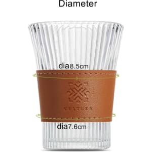A clear glass cup with a brown leather sleeve, featuring a brand logo, highlighting its dimensions.