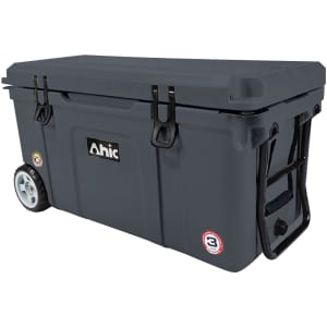 A dark grey cooler box with wheels, featuring a sturdy lid and handles, and including a logo.