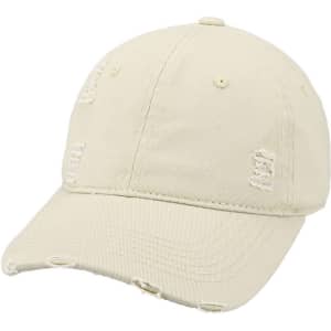 A vintage baseball cap in a pale beige colour with distressed details and a curved brim. It features a logo.