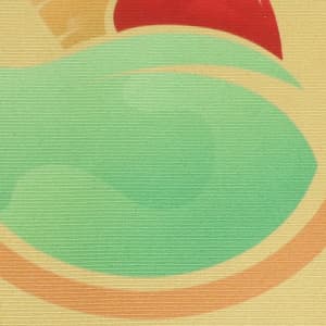 A textured mat featuring abstract shapes in green, yellow, and red, with a branding logo present.