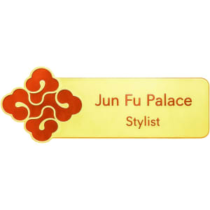 A custom metal name badge featuring a gold background with a red decorative logo and text for "Jun Fu Palace Stylist."