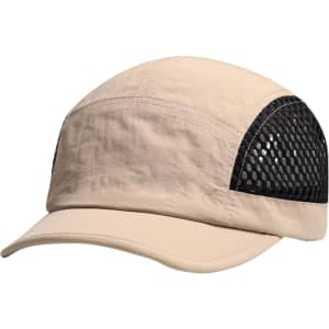 A short brimmed mesh running cap in beige with a black mesh side panel and a logo.