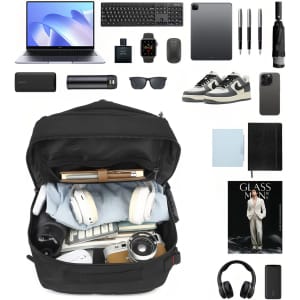 A black convertible backpack to duffel bag filled with a laptop, camera, headphones, notebooks, and various accessories.