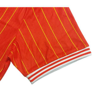 A vibrant red T-shirt with yellow stripes and white striped cuffs, featuring a logo.