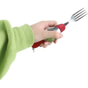 A hand holds a red and silver camping cutlery tool featuring a fork, with a textured grip.