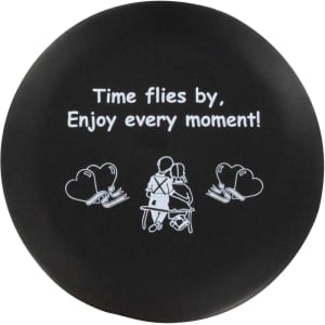 A round black stress reliever featuring a design of two seated figures and an inspirational message in white text.