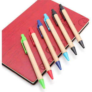 Kraft paper pens in green, red, blue, black, and turquoise arranged on a red notebook with a logo.