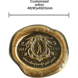 A custom antique golf ball marker in a bronze finish, featuring a decorative golf motif and a logo.