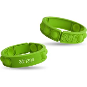 Two green silicone wristbands with raised dots, featuring one with a name printed on it and a logo.