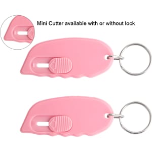 A pink mini cutter keyring with a sliding mechanism, featuring a keyring attachment and a logo.