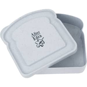 A grey, square lunch box made from bamboo fibre, featuring a logo on the lid. The lid is slightly ajar.