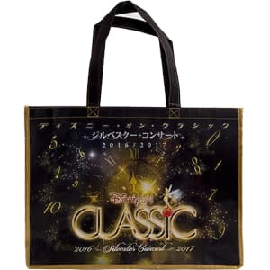 A black and gold laminated non-woven trade show bag with handles and a logo.