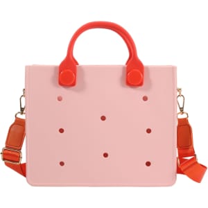 A casual tote bag in pink with red handles and dots, featuring a detachable strap and a logo.