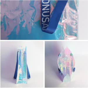 A PVC waterproof tote bag in translucent iridescent colours, featuring blue handles and a logo.