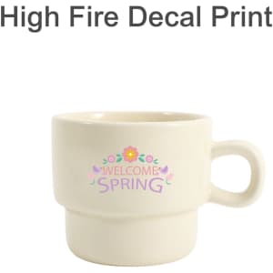 A stackable ceramic mug in cream with a floral design and branding visible.