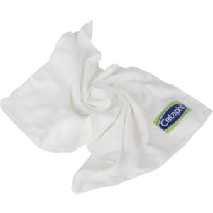 A white gym towel is folded and arranged, featuring a logo on one corner.