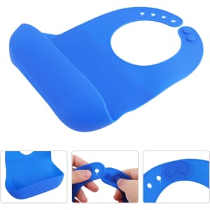 A blue silicone bib with snap closure featuring a wide pocket and adjustable neck. It has a logo on the side.
