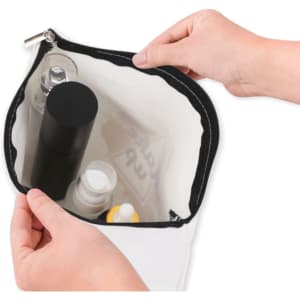 A rectangle canvas cosmetic bag in white with a black zipper, filled with various toiletry items.