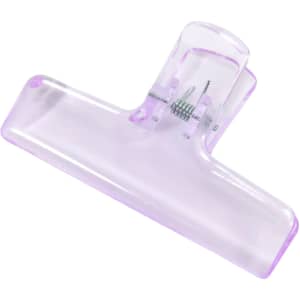 A translucent purple plastic clip with a spring mechanism for securing items.