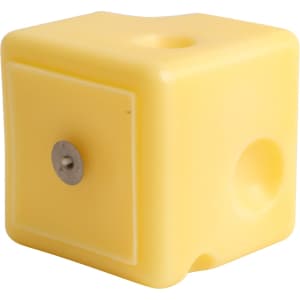 A square yellow candle shaped like cheese, featuring a smooth surface and rounded edges.
