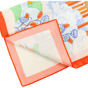 A silk chiffon scarf featuring a colourful floral and abstract design with an orange border. It has a soft, sheer texture.