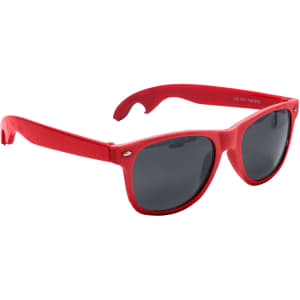 A drink bottle opener is integrated into bright red sunglasses with dark grey lenses. The sunglasses feature a logo.