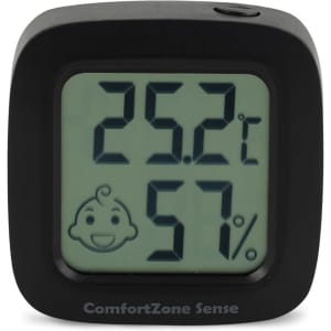 A square black digital thermometer displaying temperature and humidity readings. Features a smiling face icon.