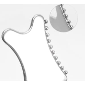 A silver Gua Sha tool with rounded edges and small beads along one side, featuring a close-up detail of the beads.