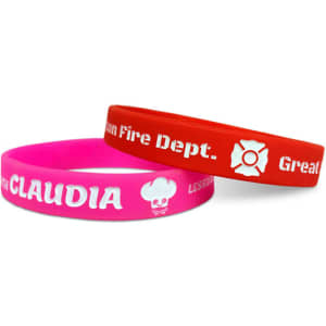 Two silicone wristbands, one pink and one red, featuring a logo and text.