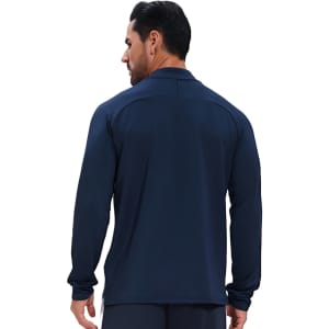 A model wears a navy polyester spandex stand-up collar quarter-zip raglan jacket, featuring long sleeves and a smooth finish.