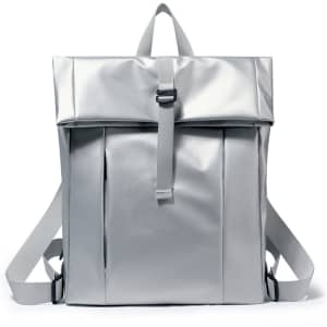 A tarpaulin roll top backpack in a sleek silver colour with adjustable straps and a front pocket.