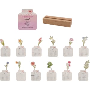 A floral-themed desk calendar for 2026 with a wooden stand. Features various flowers and pastel colours.