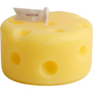 A round yellow candle shaped like cheese, featuring holes and a small flag on top.