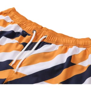 Women's board shorts in orange, navy, and white with a drawstring and pocket, featuring a wave pattern.