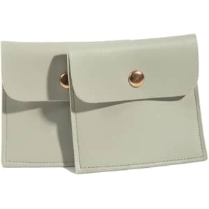 A set of square, pale green PU leather jewelry pouches with a snap closure and subtle stitching detail.
