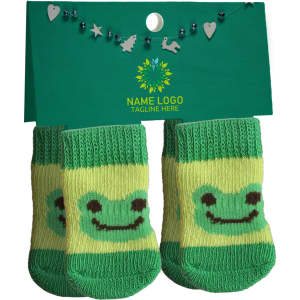 Green pet socks featuring a smiling frog design, displayed on a card with a logo and decorative elements.